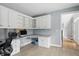 Well-lit office space with custom cabinetry, desk, and a view of the front entrance at 9703 Fortune Dr, Fishers, IN 46037