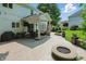 Inviting outdoor patio with a built-in fire pit, comfortable seating, and a grilling area, perfect for entertaining at 9703 Fortune Dr, Fishers, IN 46037