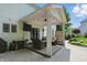 Covered patio with outdoor kitchen, seating area, and access to a landscaped backyard at 9703 Fortune Dr, Fishers, IN 46037