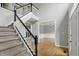 Carpeted staircase with decorative black and white railings leading to a formal dining room at 9703 Fortune Dr, Fishers, IN 46037