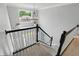 Elegant staircase with black and white railings leading to the upper level at 9703 Fortune Dr, Fishers, IN 46037