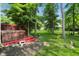 Backyard with a wooden deck featuring a hot tub surrounded by lush greenery at 10402 Shakamak Way, Indianapolis, IN 46239