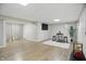 Finished basement with wood flooring, neutral paint, a table with stools, and a mounted TV at 10402 Shakamak Way, Indianapolis, IN 46239
