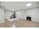 Finished basement featuring wood flooring, neutral paint, and a decorative fireplace at 10402 Shakamak Way, Indianapolis, IN 46239