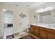 Bright bathroom features a double vanity with wood cabinets and stylish decorative accents at 10402 Shakamak Way, Indianapolis, IN 46239