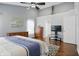Spacious bedroom features hardwood floors, neutral walls, ceiling fan, and a flat screen tv at 10402 Shakamak Way, Indianapolis, IN 46239