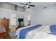 Spacious bedroom features hardwood floors, neutral walls, ceiling fan, and a flat screen tv at 10402 Shakamak Way, Indianapolis, IN 46239
