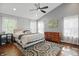 Spacious bedroom features hardwood floors, neutral walls, ceiling fan, and natural light at 10402 Shakamak Way, Indianapolis, IN 46239