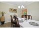 Elegant dining room with a table set for dinner, decorative lighting, and hardwood floors at 10402 Shakamak Way, Indianapolis, IN 46239