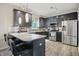Modern kitchen featuring dark cabinets, stainless steel appliances, and a stylish breakfast bar at 10402 Shakamak Way, Indianapolis, IN 46239
