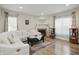 Cozy living room featuring a fireplace, hardwood floors, and ample seating with natural light at 10402 Shakamak Way, Indianapolis, IN 46239