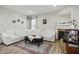 Spacious living room featuring plush seating, a fireplace, and hardwood flooring at 10402 Shakamak Way, Indianapolis, IN 46239