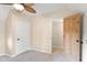 Bright bedroom with neutral carpet, ceiling fan, with view into hallway and closet at 106 N Blake St, Sheridan, IN 46069