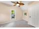 Comfortable bedroom with two windows, neutral carpet, ceiling fan, and a closet at 106 N Blake St, Sheridan, IN 46069