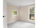 Spacious bedroom with neutral carpet, two windows with views, with light walls at 106 N Blake St, Sheridan, IN 46069