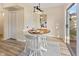 Bright dining area featuring a wood table, modern lighting, and sliding glass doors at 106 N Blake St, Sheridan, IN 46069