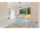 Dining area with bright walls, white table set with three chairs, and modern light fixture at 106 N Blake St, Sheridan, IN 46069