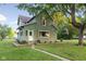 Charming two-story home with green siding, brown shutters, and a well-manicured lawn at 106 N Blake St, Sheridan, IN 46069