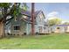 Spacious backyard showcasing the home's back facade, a wooden deck, and detached garage at 106 N Blake St, Sheridan, IN 46069