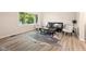 Inviting living room showcasing hardwood floors, a cozy sofa, and large window views at 106 N Blake St, Sheridan, IN 46069