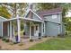 Home exterior featuring a covered awning, well-kept lawn, and tasteful landscaping at 106 N Blake St, Sheridan, IN 46069