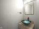 Stylish powder room features a vessel sink and modern fixtures at 10903 Greenleaf Dr, Indianapolis, IN 46229