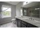 Dual vanity bathroom featuring a tile shower, and abundant natural light at 10903 Greenleaf Dr, Indianapolis, IN 46229