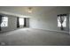 Expansive primary bedroom with plush carpet and plentiful natural light at 10903 Greenleaf Dr, Indianapolis, IN 46229