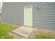 Exterior shot showing the green side door to the home with concrete step at 10903 Greenleaf Dr, Indianapolis, IN 46229