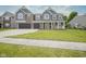 Two-story home with a two-car garage, classic columns, a porch, and a well-maintained front lawn at 10903 Greenleaf Dr, Indianapolis, IN 46229