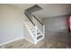 Bright foyer with updated flooring, staircase with white railing, and access to the living spaces at 10903 Greenleaf Dr, Indianapolis, IN 46229