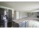 View of kitchen island, refrigerator, and view to the living room, showing the open floorplan at 10903 Greenleaf Dr, Indianapolis, IN 46229