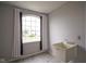 Laundry room with a large window and light-colored luxury vinyl flooring at 10903 Greenleaf Dr, Indianapolis, IN 46229
