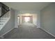 Bright living room with neutral carpet, open layout, and fresh gray paint at 10903 Greenleaf Dr, Indianapolis, IN 46229