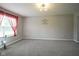 Spacious living room with modern gray walls, plush carpeting, and natural light from the large window at 10903 Greenleaf Dr, Indianapolis, IN 46229