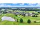 An aerial view of a golf community with well maintained lawns, homes, and serene ponds at 1135 Maclaren Ct, Franklin, IN 46131