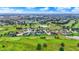 Ariel view of a community featuring an expansive golf course, luxury homes, and serene ponds at 1135 Maclaren Ct, Franklin, IN 46131
