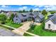 Desirable craftsman home with a manicured lawn and a three-car garage showcases its exceptional curb appeal at 1135 Maclaren Ct, Franklin, IN 46131