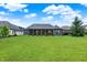 Expansive backyard featuring lush green lawn, mature trees, and a screened-in porch perfect for outdoor relaxation at 1135 Maclaren Ct, Franklin, IN 46131