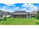 The backyard features a lush green lawn and a cozy screened-in porch for relaxing at 1135 Maclaren Ct, Franklin, IN 46131