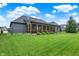 Backyard view of this home shows a spacious lawn and inviting screened-in porch at 1135 Maclaren Ct, Franklin, IN 46131