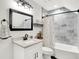 Chic bathroom featuring a vanity with modern fixtures, decorative mirror, and tiled shower-tub combo provides a relaxing retreat at 1135 Maclaren Ct, Franklin, IN 46131