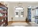 Inviting entryway with stylish double doors, elegant light fixture, and hardwood floors at 1135 Maclaren Ct, Franklin, IN 46131