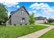 Stylish home exterior featuring gray facade, lush green lawn, and manicured landscaping at 1135 Maclaren Ct, Franklin, IN 46131