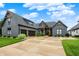 Charming gray home with two-car garage, manicured lawn, and inviting front entrance and professionally landscaped at 1135 Maclaren Ct, Franklin, IN 46131