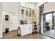 Bright kitchen featuring white cabinetry, a sliding ladder, and access to an outdoor patio with a grill at 1135 Maclaren Ct, Franklin, IN 46131