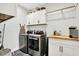 Functional laundry room featuring modern appliances, white cabinets, and ample counter space at 1135 Maclaren Ct, Franklin, IN 46131