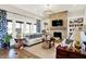 Bright living room featuring a stone fireplace, built-in bookshelves, and comfortable seating at 1135 Maclaren Ct, Franklin, IN 46131