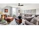 Inviting living room with vaulted ceilings, plush seating, and modern ceiling fan provides a comfortable gathering space at 1135 Maclaren Ct, Franklin, IN 46131