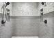 Modern walk-in shower featuring stylish gray tiling, dual shower heads, and tiled shower niches at 1135 Maclaren Ct, Franklin, IN 46131